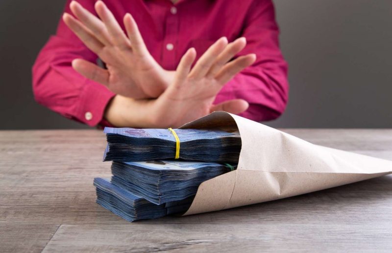 businessman-refusing-money-in-the-envelope-2026-01-07-02-04-42-utc (1)