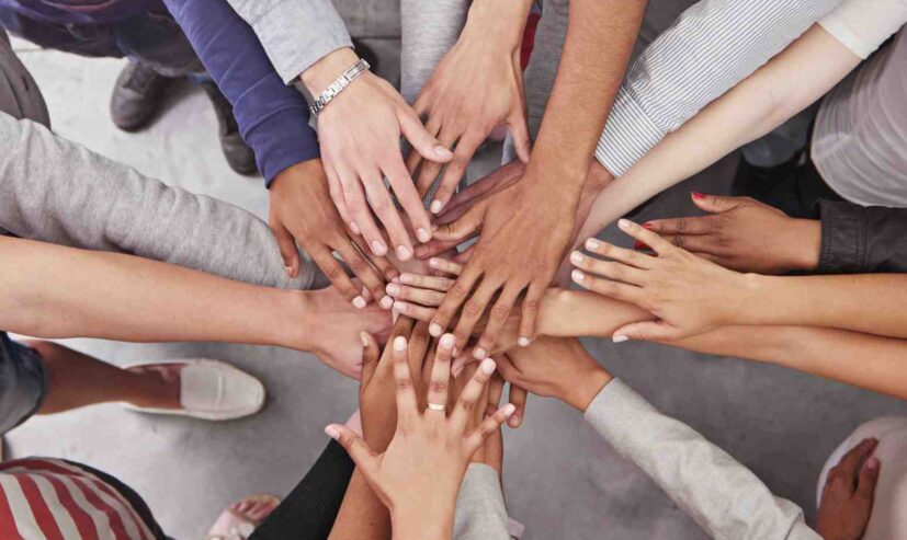 cropped-shot-of-a-business-team-standing-in-a-circ-2026-01-09-11-19-08-utc (1)