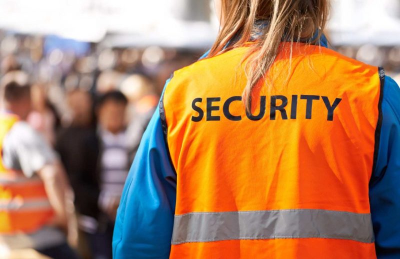 rearview-shot-of-a-security-officer-standing-outdo-2026-03-25-03-18-09-utc (1)